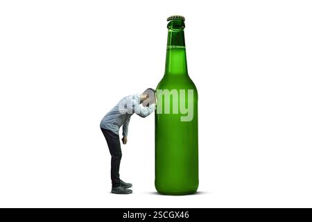 Person leaning sadly against a surreal giant beer bottle isolated on white Stock Photo
