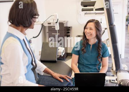 Doctor talking to patient and taking notes Stock Photo
