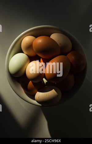 Bowl of brown eggs on table Stock Photo
