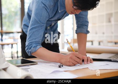 Young architect sketching house plans Stock Photo