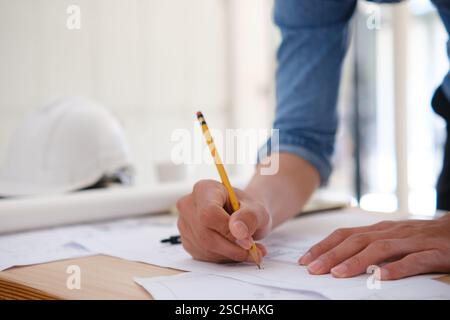 Young architect sketching house plans Stock Photo