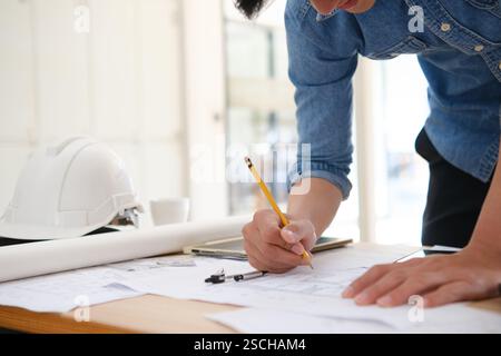 Young architect sketching house plans Stock Photo