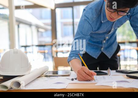 Young architect sketching house plans Stock Photo