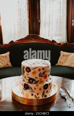 two tier white wedding cake with pressed flowers Stock Photo