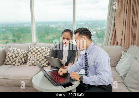 Collaboration During Business Meetings in a Modern Workspace Featuring Laptops Stock Photo