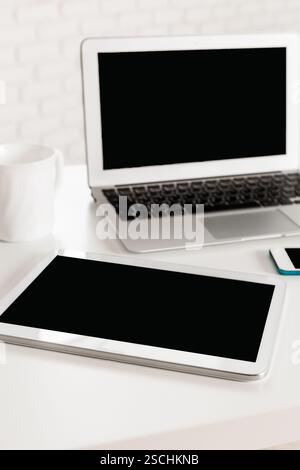 Modern workspace with digital devices showcasing productivity and organization in a minimalist setting Stock Photo