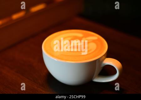 Close-up cappuccino latte coffee cup with rich foam in warm light Stock Photo