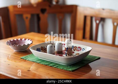 Rustic wood furniture and ceramic salt and pepper shaker with bowl on wooden table Stock Photo