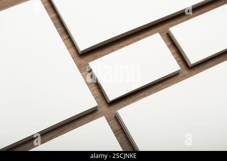 Various blank rectangular surfaces arranged on a wooden table showcasing potential for creativity and design projects Stock Photo