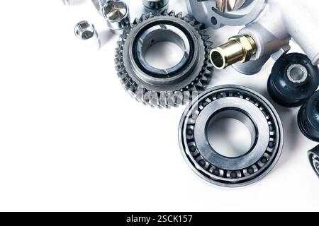 Various mechanical parts and components arranged neatly on a white surface for inspection and maintenance purposes Stock Photo