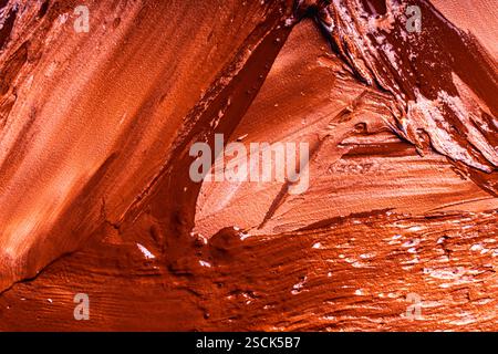Abstract background with the texture of plaster or oil paint in rich red color. Seamless background with large brush strokes. Rough stylized texture w Stock Photo