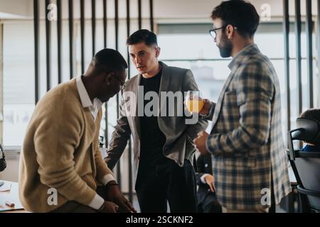 Multicultural business workers brainstorming and discussing a project together Stock Photo