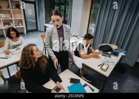 Students engaged in learning during a classroom group study session Stock Photo