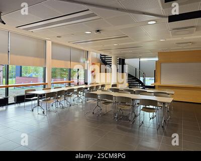 Modern Office Or Cafe Interior With Table, Chairs, Waiting Area and Staircase Stock Photo