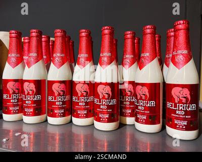 Kyiv, Ukraine - February 04, 2025: Vertical collection of Delirium Red beer bottles showcasing vibrant labels in rows. Stock Photo