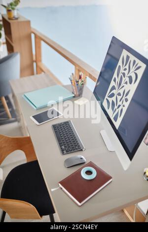 Office desk featuring various devices like laptop, keyboard, and tablet arranged on a wooden desk with copy space in background providing an organized and productive work environment Stock Photo