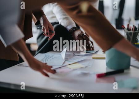 Business professionals collaborating over documents in modern office environment Stock Photo