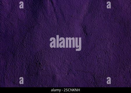 Dark purple textured wall surface providing an artistic backdrop ideal for design or creative projects. Perfect for artistic applications or backdrops Stock Photo