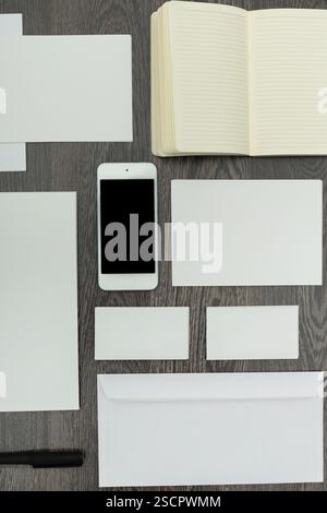 Various office supplies arranged neatly on a wooden table during a productive work session Stock Photo
