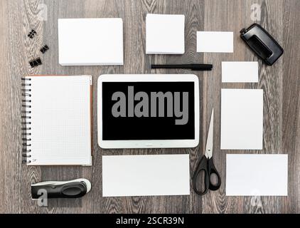 Collection of stationery items arranged neatly on a wooden desk surface for office or creative work Stock Photo