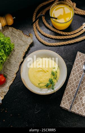 Creamy mashed potatoes garnished with fresh microgreens, in stylish and elegant food presentation Stock Photo