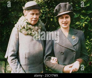 Queen Mary with Princess Elizabeth, April 1944, (1951). 'Queen Mary with Princess Elizabeth at the party held to celebrate the eighteenth birthday of the Princess'. Queen Mary of Teck (1867-1953) with her granddaughter the Princess Elizabeth (born 1926, future Queen Elizabeth II). From &quot;The Queen Mother&quot;, by Marion Crawford (&quot;Crawfie&quot;), governess of Princess Margaret and Princess Elizabeth (the future Queen Elizabeth II). [George Newnes Limited, London, 1951] (Colorised black and white print). Stock Photo