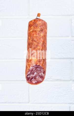 sausage salami. Sausages falling in the air isolated on white background. Food levitation concept. Stock Photo