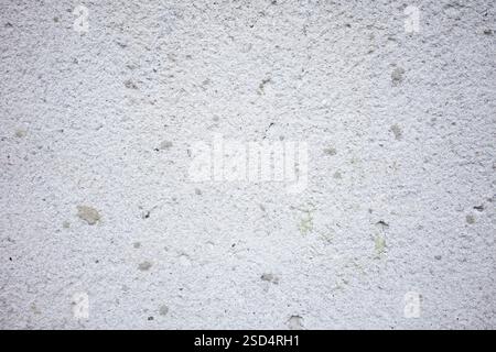 This surface features a light gray tone, exhibiting a rough texture with small spots and variations that create a unique visual appeal, suitable for b Stock Photo