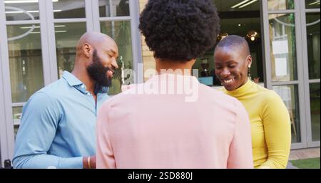 In office, colleagues having conversation and laughter during casual gathering Stock Photo
