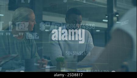Image of colleagues discussing project details at office table with digital overlay Stock Photo