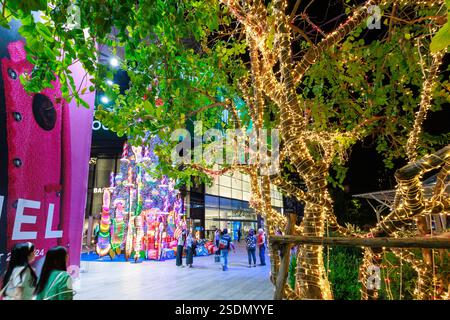 Bangkok, Thailand - January 9 2024 : View The lighting or lighting fixtures on the tree at in front of Emquartier at Phrom Phong Station in Bangkok. Stock Photo