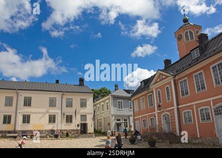 The central square of Old Porvoo, Finland, on a sunny day with scattered clouds, showcasing historic buildings. Stock Photo