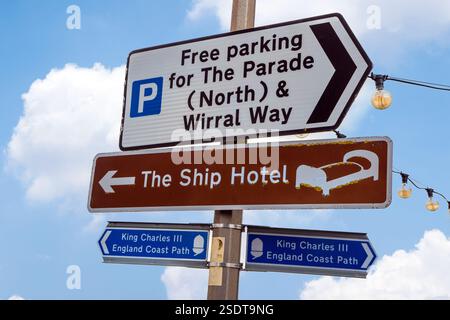 Signpost waymarker for the Wirral Way and the new King Charles III England coast path on the promenade in the Cheshire Wirral village of Parkgate. Stock Photo