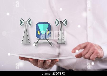 Smart train concept above a tablet held by a man in background Stock Photo
