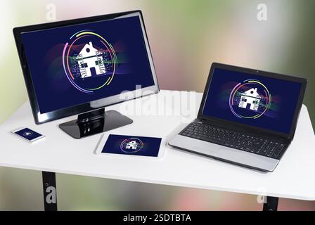 Smart home concept shown on different information technology devices Stock Photo