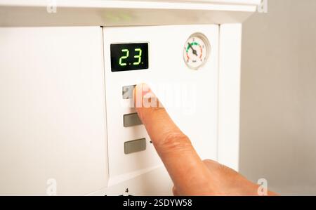 The man uses the keys to activate the natural gas boiler Stock Photo