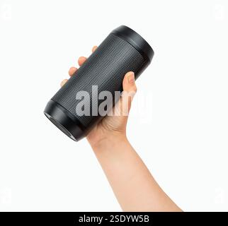 Close-up portable wireless speaker in hand isolated on white background. Black mobile wireless bluetooth speaker with ribbed texture in female hand. C Stock Photo