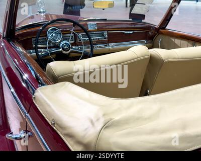 Classic convertible showcases timeless elegance in a modern exhibition hall Stock Photo
