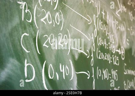 Maths lesson on the blackboard. Close view. Stock Photo