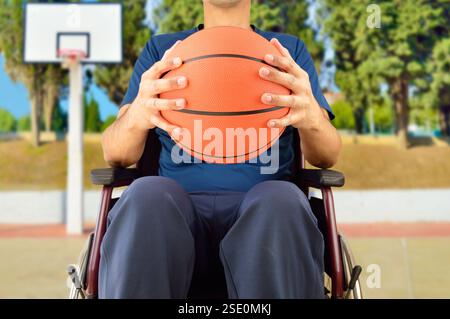 cropped basketball player in wheelchair at outdoors Stock Photo