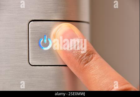 Close up of finger pressing ON button Stock Photo