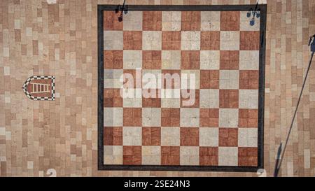 Large chessboard seen from above. Chess square in the center of Marostica, a medieval town in Italy. Texture and background of chessboard squares Stock Photo