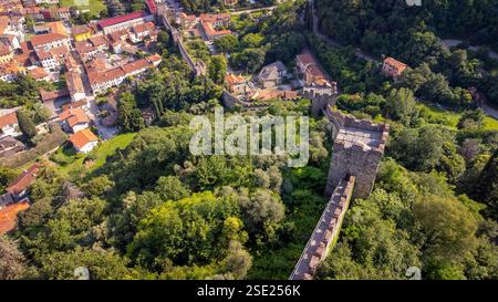 Long medieval walls seen from above in the middle of the forest. Aerial view of ancient city walls going up the mountain. Marostica, Italy Stock Photo