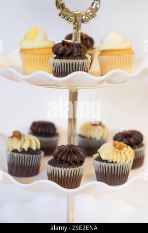 Chocolate and lemon cupcakes on a traditional cake stand for Easter and afternoon tea; concept for teatime, Birthdays and Mother's Day. Stock Photo