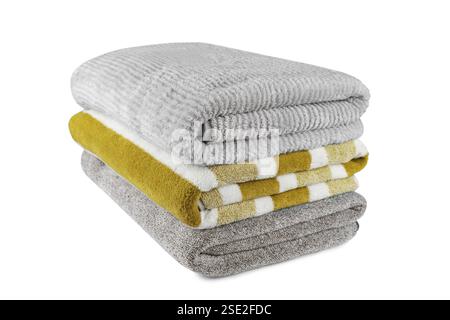 Soft fluffy striped grey and yellow bath towels folded in stack isolated on white background. Terry cloth, striped pattern towel texture, cotton bath Stock Photo