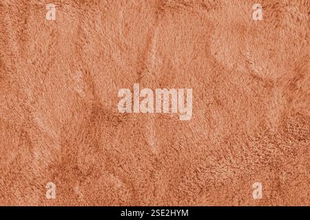 Soft shaggy orange carpet texture. Fluffy synthetic textile fur, plush textile, blanket cloth background. Wallpaper, backdrop, solid color Stock Photo