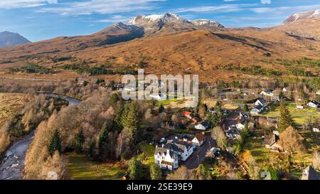 Kinlochewe Wester Ross Scotland view over the village houses and Kinlochewe River in winter to Beinn Eighe mountain Stock Photo