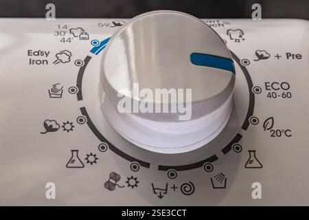 Washing in a washing machine, ecological program, saving energy and water washing machine in the bathroom Stock Photo