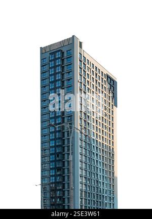 Modern skyscraper with a sleek architectural design and glass windows. Tall commercial and residential high-rise building representing urban developme Stock Photo