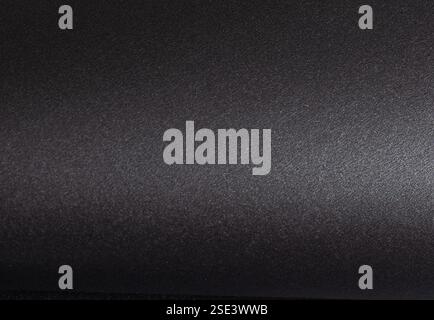 Black paper texture with a smooth, monochrome surface. Elegant and stylish background with a rich, glossy or satin finish. Blank sheet for art, design Stock Photo